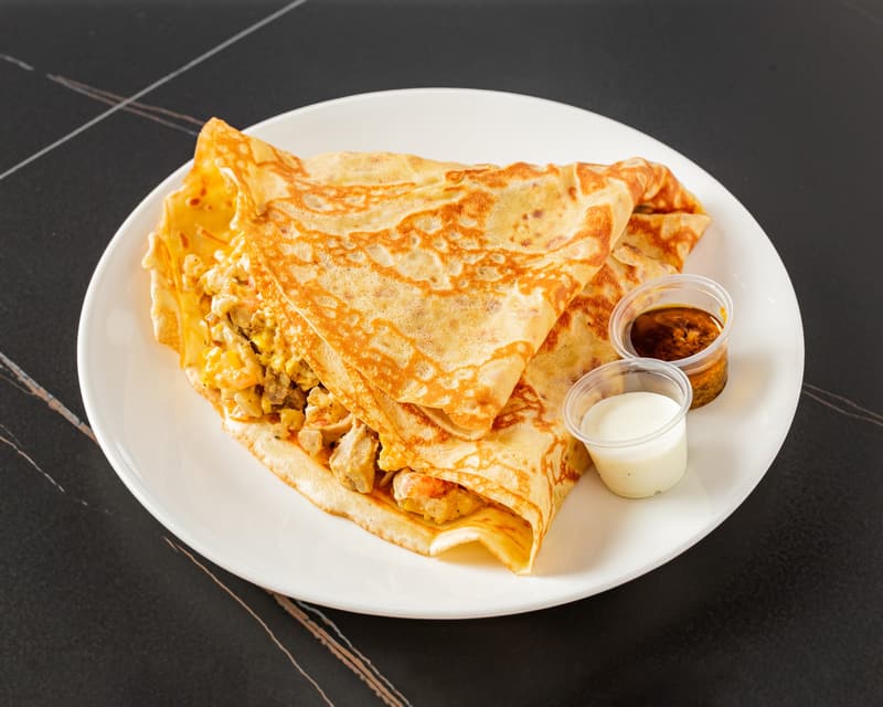 Chicken Royal Crêpe folded open to show the seasoned chicken filling