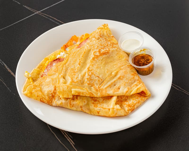 Egg, Ham & Cheese Crêpe with two small cups of sauce