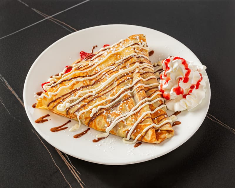 Strawnana Crêpe with strawberry sauce, chocolate drizzle, and whipped cream