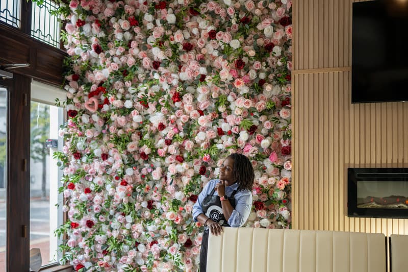 The dining room: rose wall, cream banquette, and the big front windows on Washington Street
