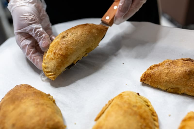 Golden hand pies fresh from the oven on a parchment-lined tray